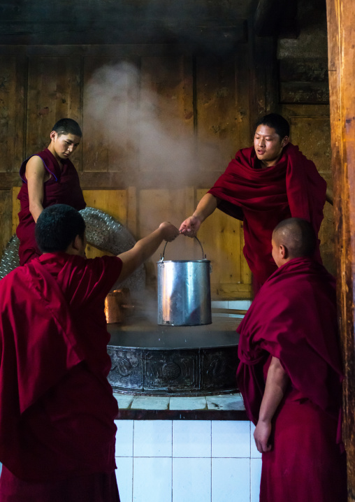 Monks in the kitchen of Rongwo monastery, Tongren County, Longwu, China