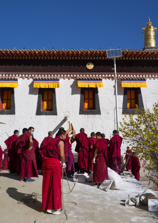 Monks preparing the painting of a temple in Rongwo monastery, Tongren County, Longwu, China