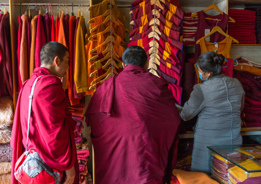 Monks buying robes in a shop, Tongren County, Longwu, China
