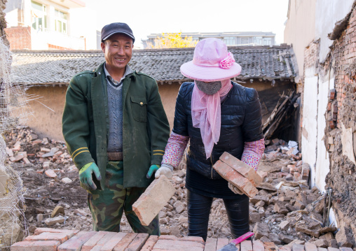 House being renovated by chinese workers in conservation area, Gansu province, Linxia, China