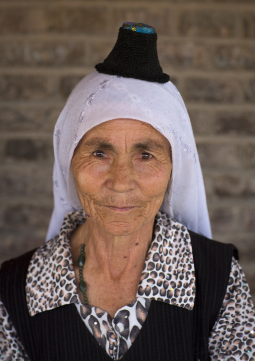 Uyghur Woman Wearing The Smallest Hat In The World, Keriya, Xinjiang Uyghur Autonomous Region, China