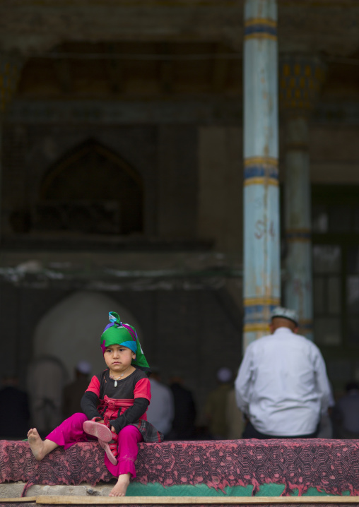Little Uyghur Girl And Old Uyghur Man in Keriya mosque, Xinjiang Uyghur Autonomous Region, China