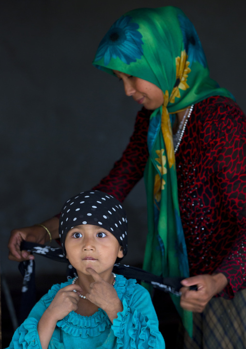 Uyghur Woman Tying Her Daughter Scarf, Xinjiang Uyghur Autonomous Region, China