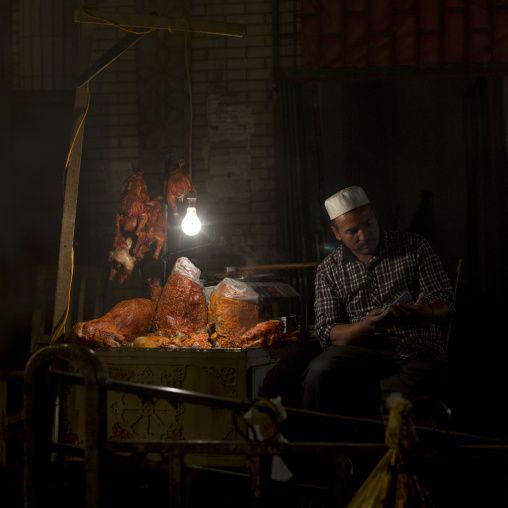 Uyghur Man At His Foodstall In Night Market, Hotan, Xinjiang Uyghur Autonomous Region, China