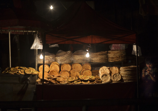 Young Uyghur Man Selling Bread In Night Market, Hotan, Xinjiang Uyghur Autonomous Region, China