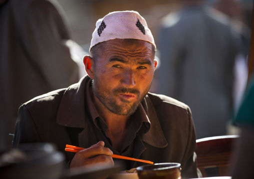Uyghur Man Eating In Serik Buya Market, Yarkand, Xinjiang Uyghur Autonomous Region, China