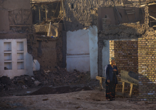 Uyghur Woman And Demolished Houses, Old Town Of Kashgar, Xinjiang Uyghur Autonomous Region, China