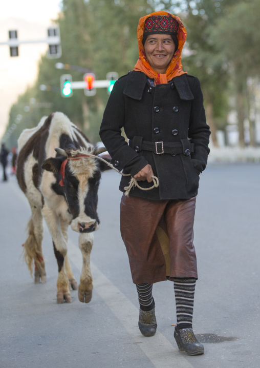 Tajik Woman with her cow , Xinjiang Uyghur Autonomous Region, China