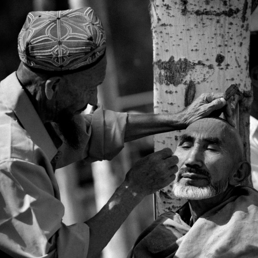 Uyghur Barber Shaving A Customer, Opal Village Market, Xinjiang, China, Xinjiang Uyghur Autonomous Region, China