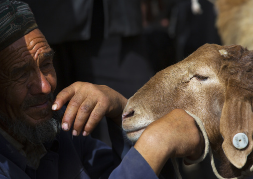 Uyghur Man and his sheep, Opal Village Market, Xinjiang, China, Xinjiang Uyghur Autonomous Region, China