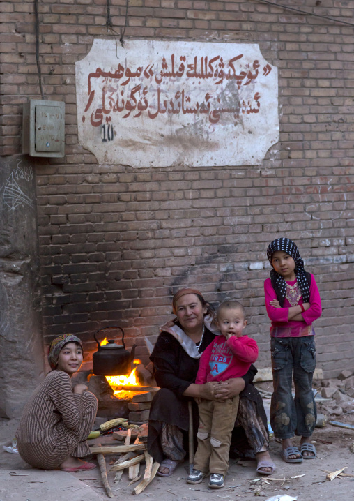 Uyghur Family making fire in the street, Kashgar, Xinjiang Uyghur Autonomous Region, China