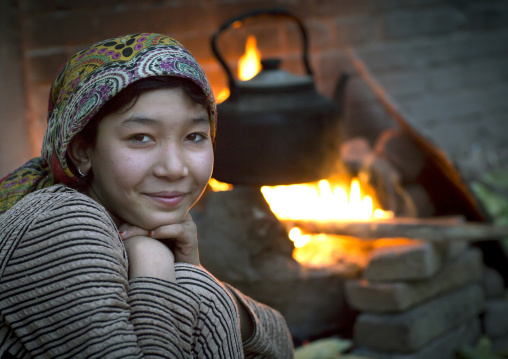 Young Uyghur Woman And Wood Stove, Kashgar, Xinjiang Uyghur Autonomous Region, China