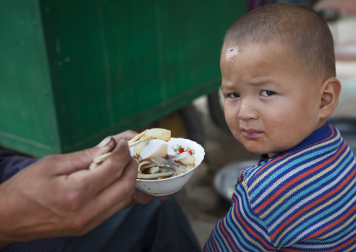 Giving Food To A Uyghur Toddler, Keriya, Xinjiang Uyghur Autonomous Region, China