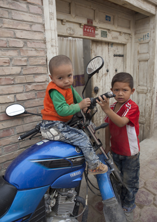 Young Uyghur Boys Playing With A Motorcycle, Keriya, Old Town, Xinjiang Uyghur Autonomous Region, China