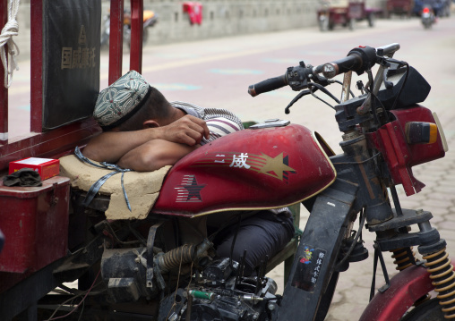 Man Sleeping On His Motorcycle, Xinjiang Uyghur Autonomous Region, China
