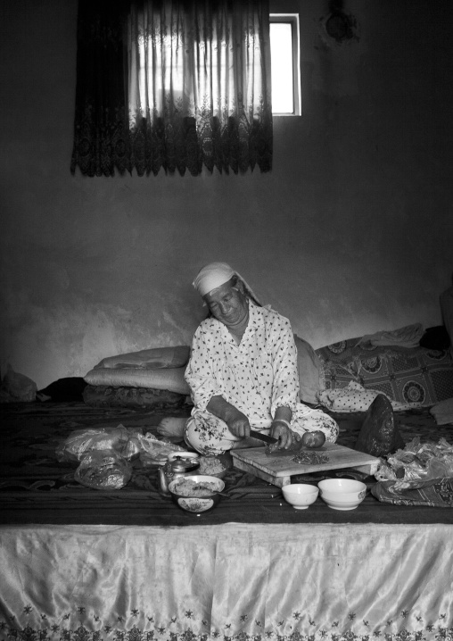 Woman Preparing Food In Her Home, Keriya, Old Town, Xinjiang Uyghur Autonomous Region, China