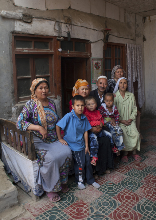 Uyghur Family Outside Their House, Minfeng, Xinjiang Uyghur Autonomous Region, China