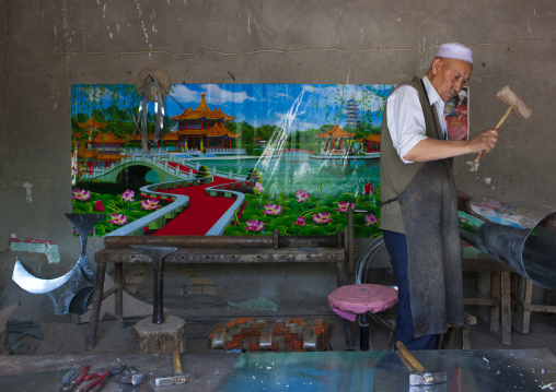 Uyghur Blacksmith Man Working, Minfeng, Xinjiang Uyghur Autonomous Region, China