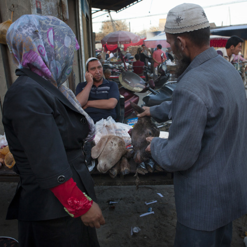 Uyghur Couple Chosing A Mutton Head, Yarkand, Xinjiang Uyghur Autonomous Region, China