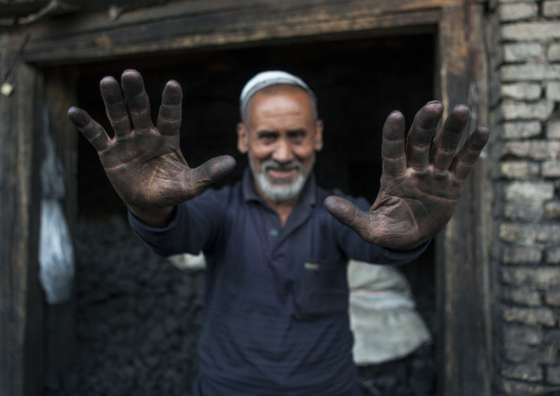 Uyghur Men Selling Coal Showing His Hands Covered By Dust, Yarkand, Xinjiang Uyghur Autonomous Region, China