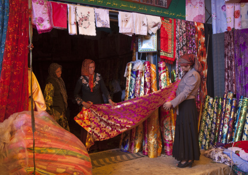 Uyghur Women Choosing Cloth In Serik Buya Market, Yarkand, Xinjiang Uyghur Autonomous Region, China