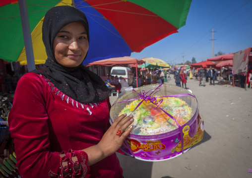 Young Uyghur Woman With big Cake, Serik Buya Market, Yarkand, Xinjiang Uyghur Autonomous Region, China