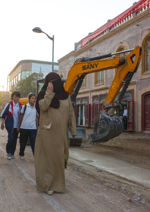 Women Passing By A Construction Site in the old town, Kashgar, Xinjiang Uyghur Autonomous Region, China