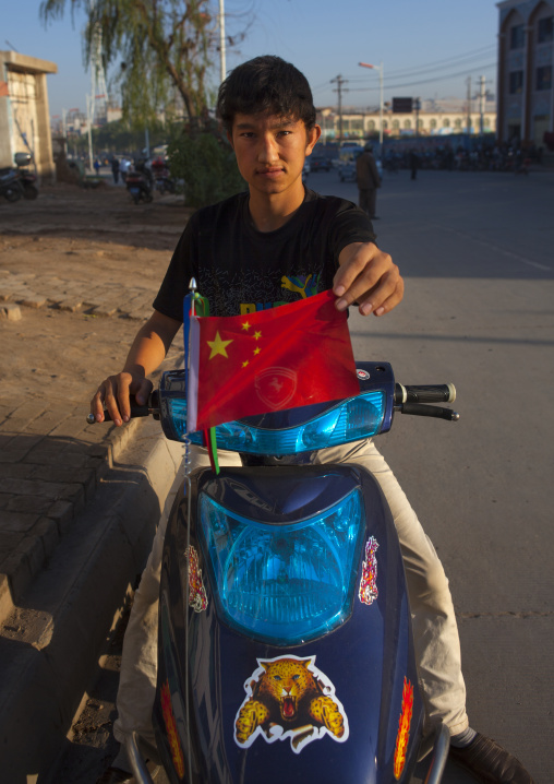 Uyghur Boy Showing A Chinese Flag, Kashgar, Xinjiang Uyghur Autonomous Region, China