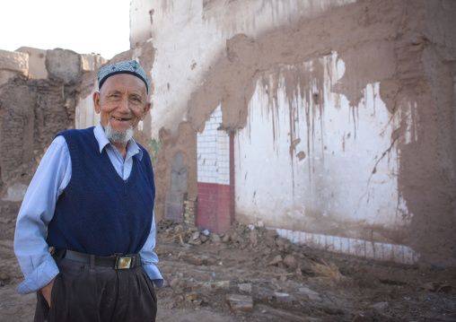 Uyghur Man In Front Of Demolished House, Old Town Of Kashgar, Xinjiang Uyghur Autonomous Region, China