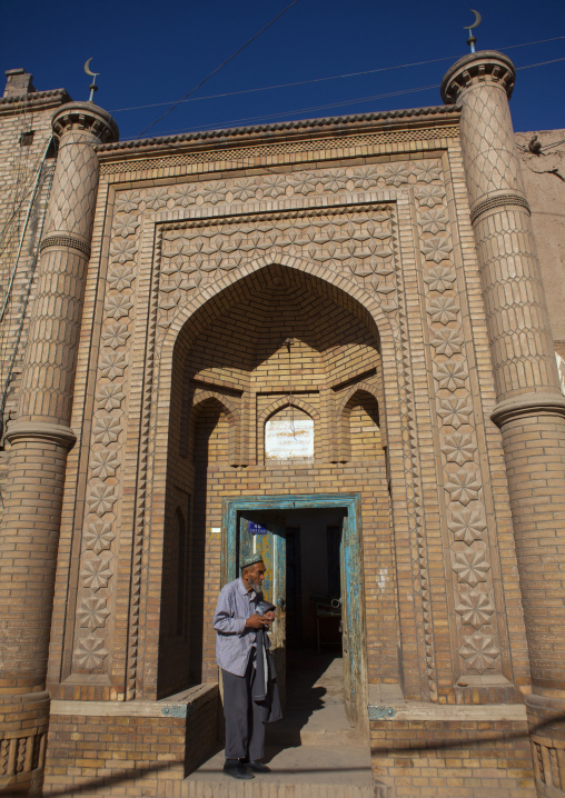 Uyghur Man At The Entrance Of A Mosque, Kashgar, Xinjiang Uyghur Autonomous Region, China