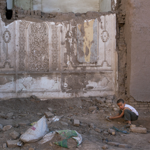 Kid In The Rubble Of A Demolished House, Old Town Of Kashgar, Xinjiang Uyghur Autonomous Region, China