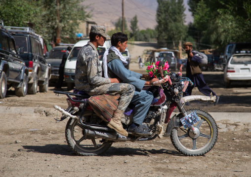 Men riding a motorcycle in the streets of the market, Badakhshan province, Ishkashim, Afghanistan