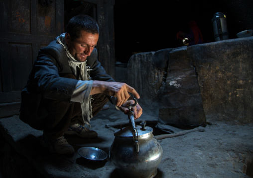 Afghan man cooking in a pamiri house, Badakhshan province, Qazi deh, Afghanistan