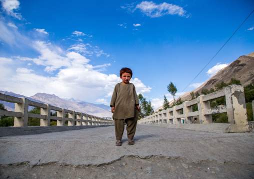 Afghan boy standing in the middle of a bridge, Badakhshan province, Khandood, Afghanistan