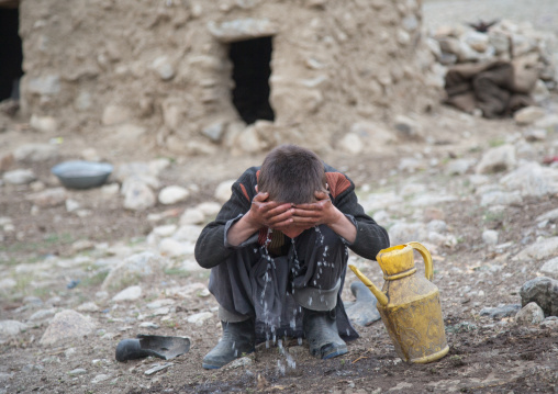 Wakhi boy washing his face in the early morning, Big pamir, Wakhan, Afghanistan