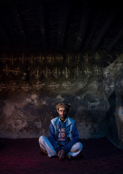 Afghan man sit inside his traditional pamiri house decorated for nowruz, Badakhshan province, Qazi deh, Afghanistan
