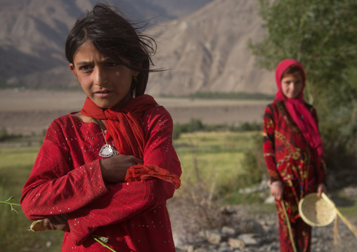 Portrait of afghan girls dressed in red clothes, Badakhshan province, Qazi deh, Afghanistan