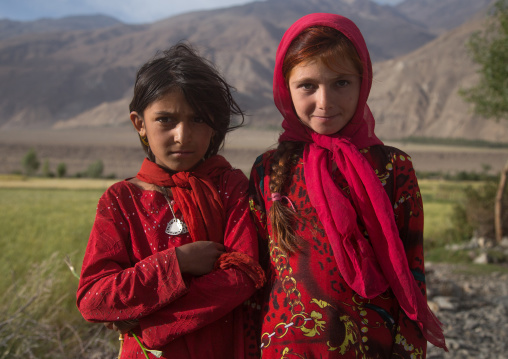 Portrait of afghan girls dressed in red clothes, Badakhshan province, Qazi deh, Afghanistan