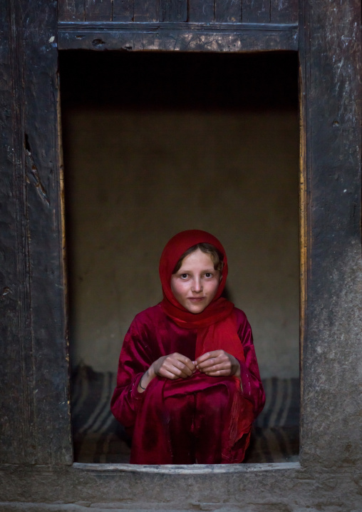 Portrait of an afghan girl with pale skin wearing red clothes, Badakhshan province, Khandood, Afghanistan