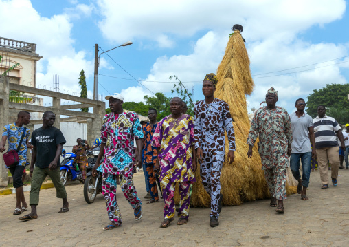 Benin, West Africa, Porto-Novo, men guiding a zangbeto guardian of the night spirit