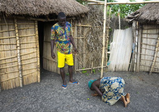 Benin, West Africa, Onigbolo Isaba, holi tribe woman paying respect to her husband in the morning