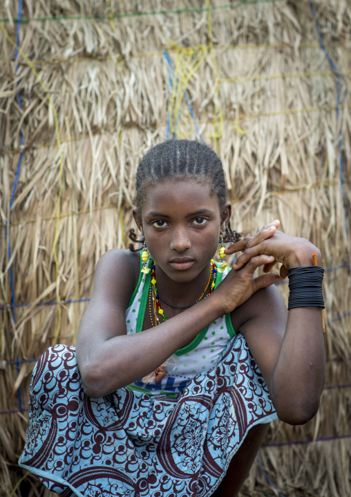 Benin, West Africa, Gossoue, a beautiful fulani peul tribe teenager at the entrance of her hut