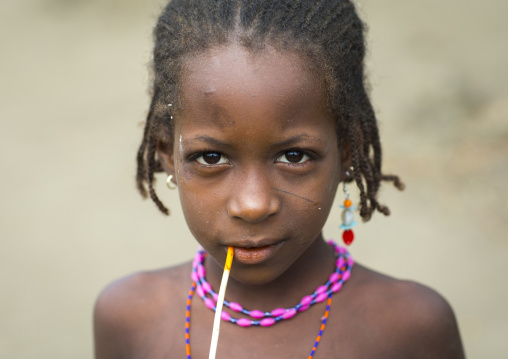 Benin, West Africa, Gossoue, fulani peul tribe girl with a stick in her mouth