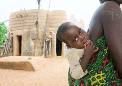 Benin, West Africa, Boukoumbé, baby in front of a traditional tata somba house