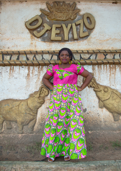 Benin, West Africa, Savalou, woman pausing in front of a king palace