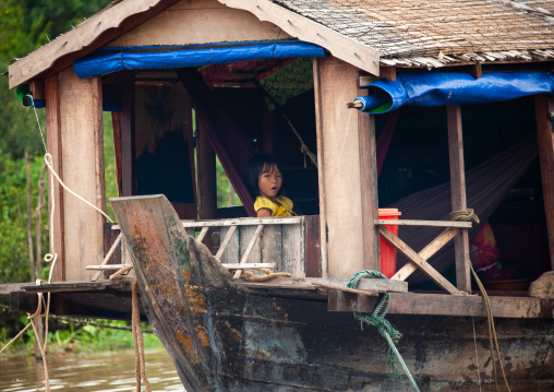 Cambodian girl in her house in the floating village on Tonle sap lake, Siem Reap Province, Chong Kneas, Cambodia
