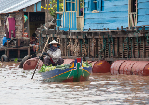 Cambodian woman selling food on boat in the floating village on Tonle Sap lake, Siem Reap Province, Chong Kneas, Cambodia