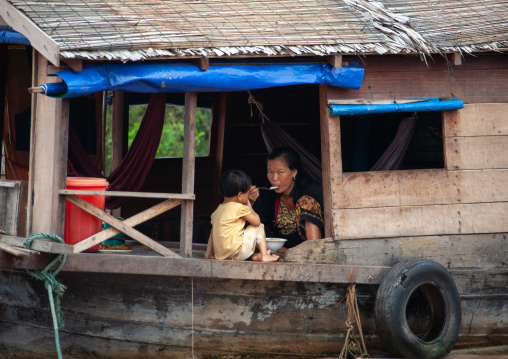 Cambodian people eating in their house in the floating village on Tonle Sap lake, Siem Reap Province, Chong Kneas, Cambodia