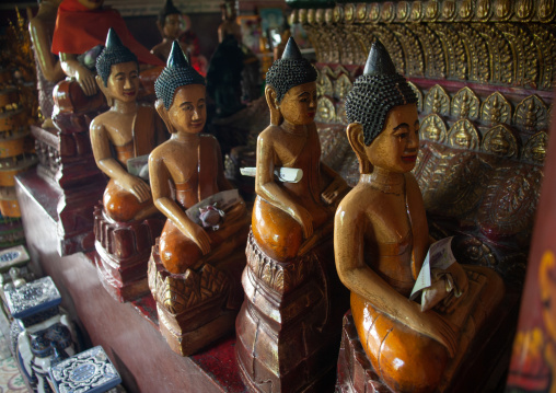 Statues with offerings in a temple, Phnom Penh province, Phnom Penh, Cambodia