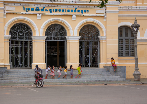 Cambodian children playing in front of the french-era post office, Phnom Penh province, Phnom Penh, Cambodia